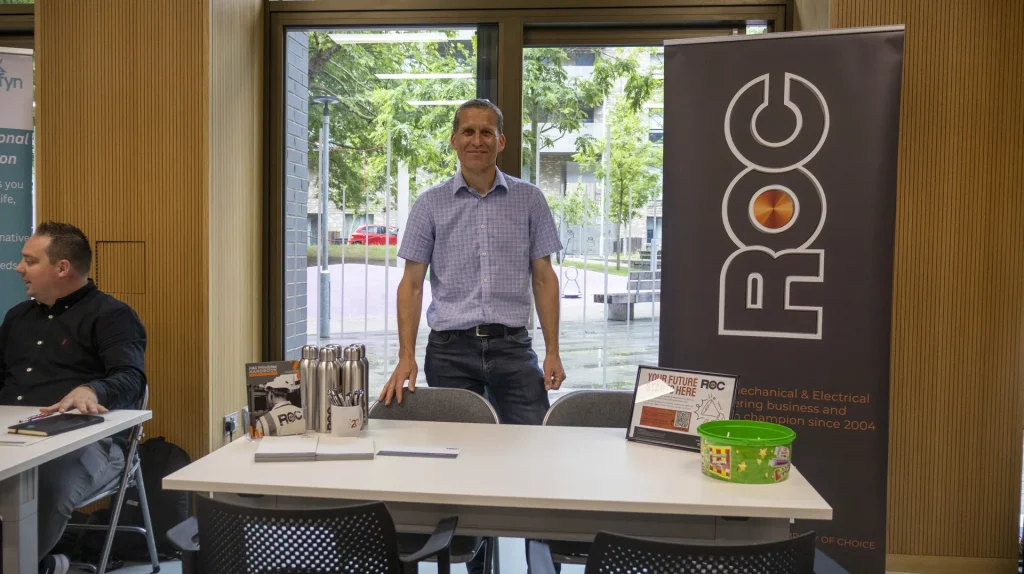 ROC employer representative smiling at a recruitment stand
