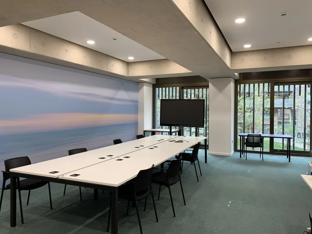 Large training room at Eckstein Road S.W. with U-shape desks facing a TV screen